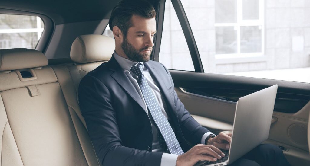 businessman in Taxi using a lapto